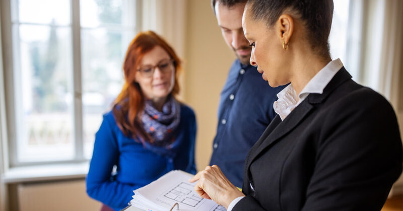 three people reading paperwork